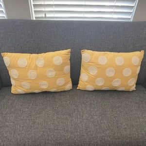 Set of two yellow throw pillows